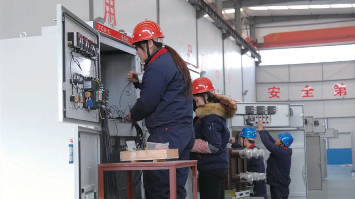 Technicians assembling and wiring switchgear cabinets